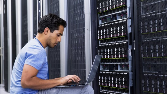 Man in front of server board.