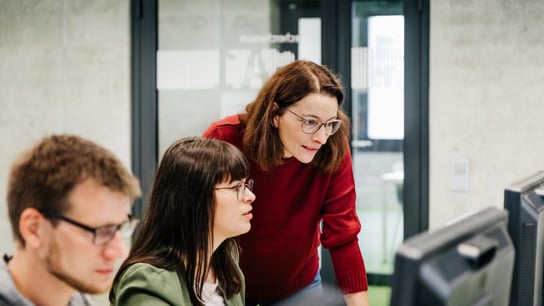 Two people in front of a computer