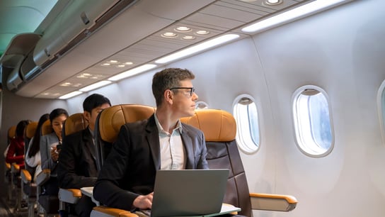 Passengers are sitting in the commercial plane.