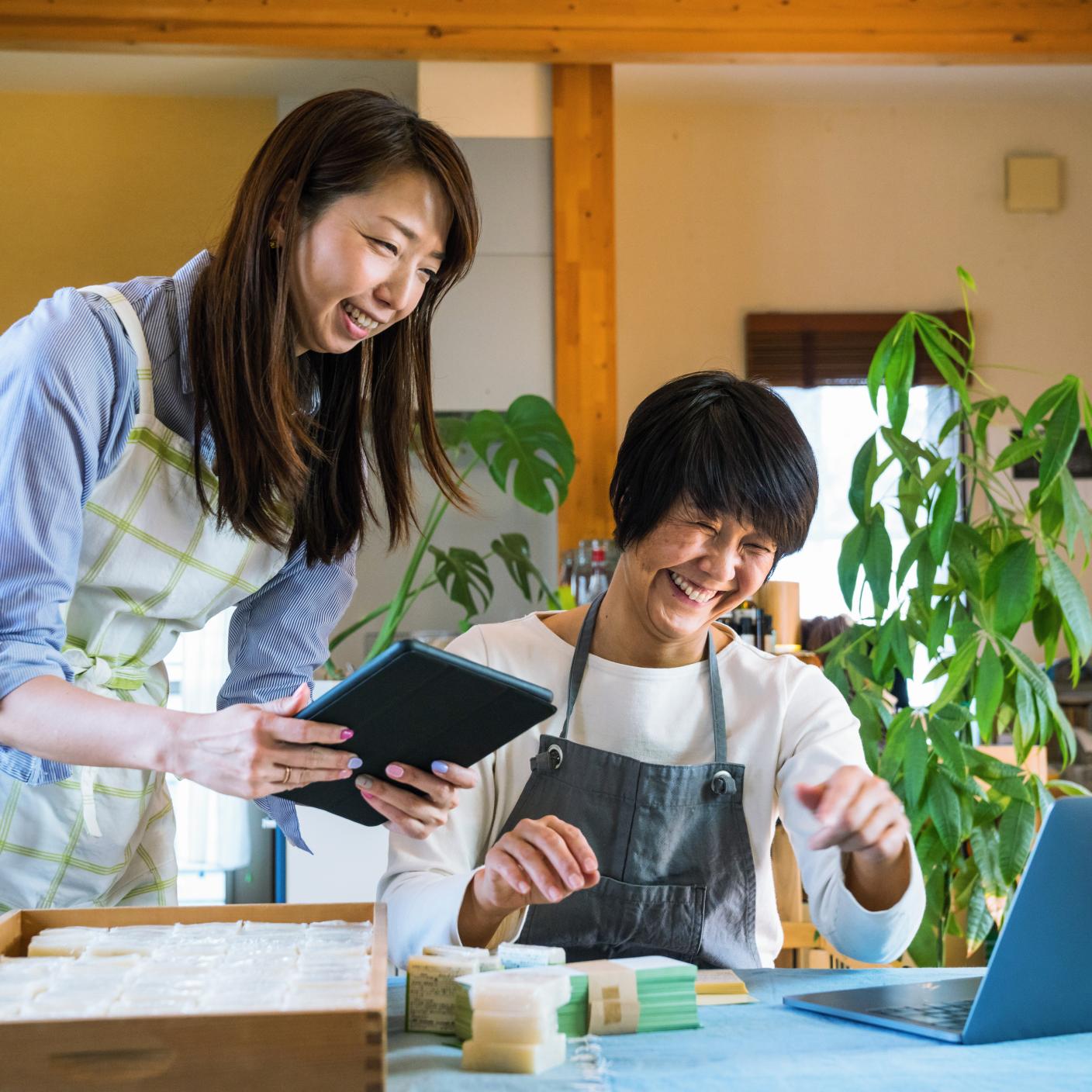 Two people in front of a computer working on their online retail store selling organic soap.