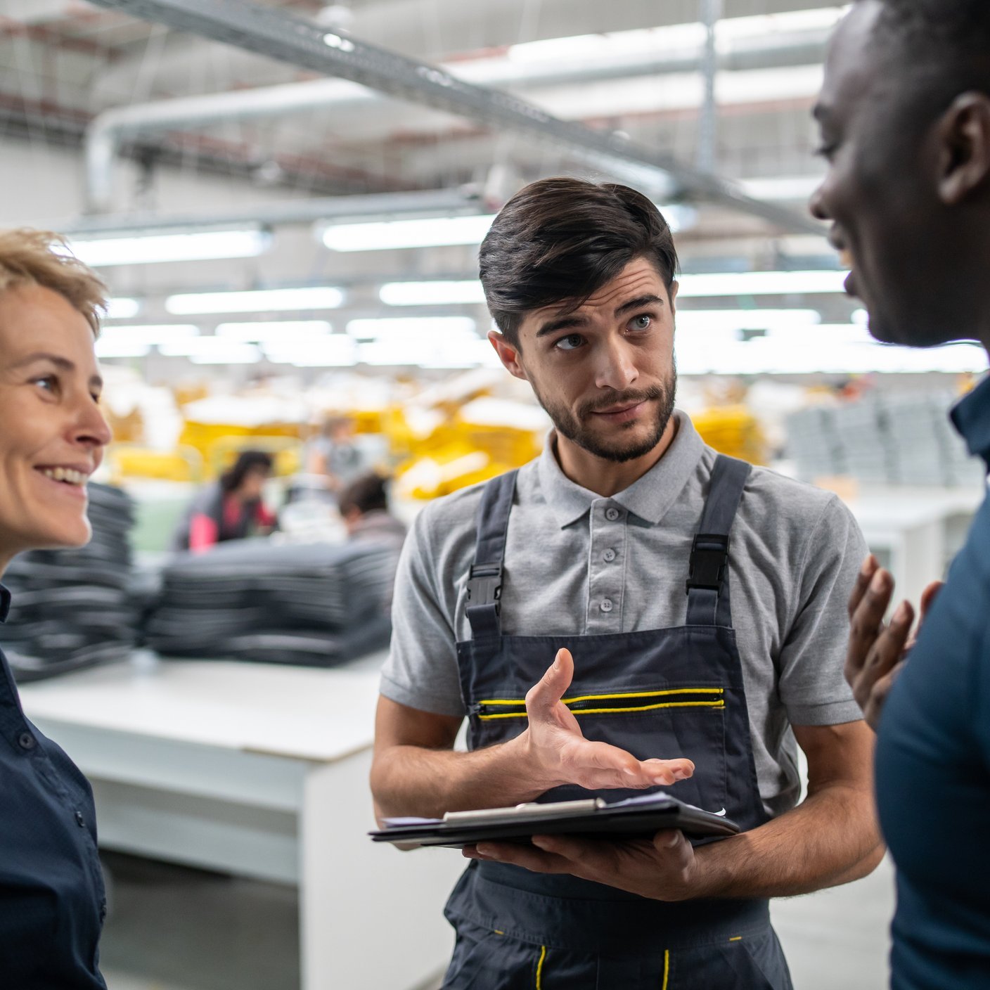 employees having discussion in a large automated production line factory