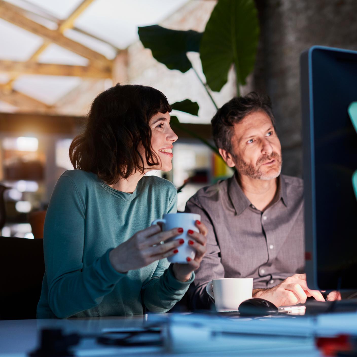 Man and women looking at laptop 