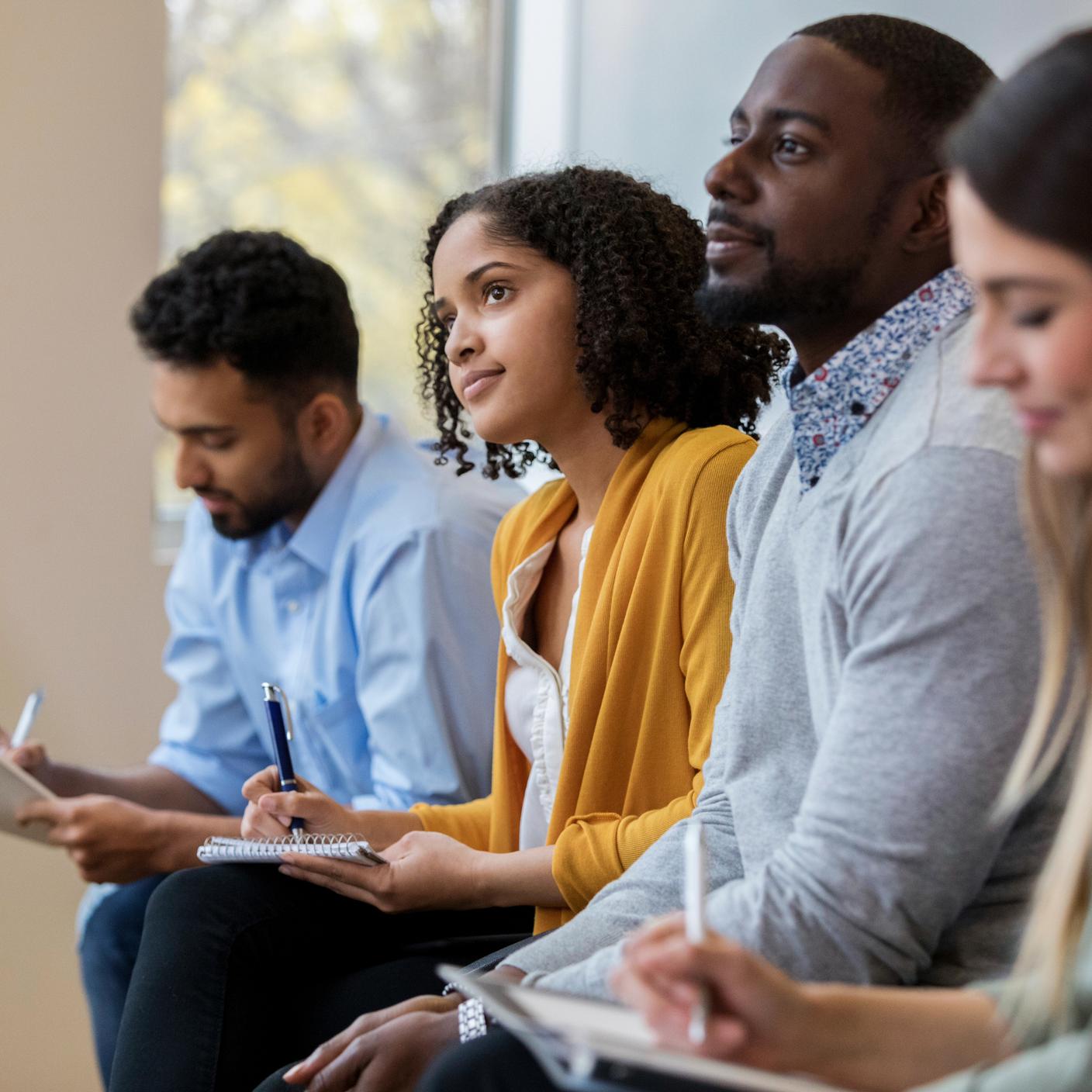 People listening to a course and taking notes