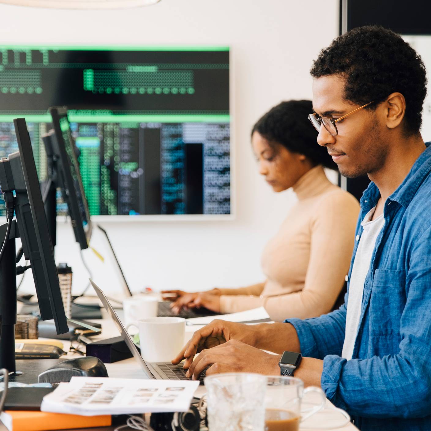 People using laptops at a desk