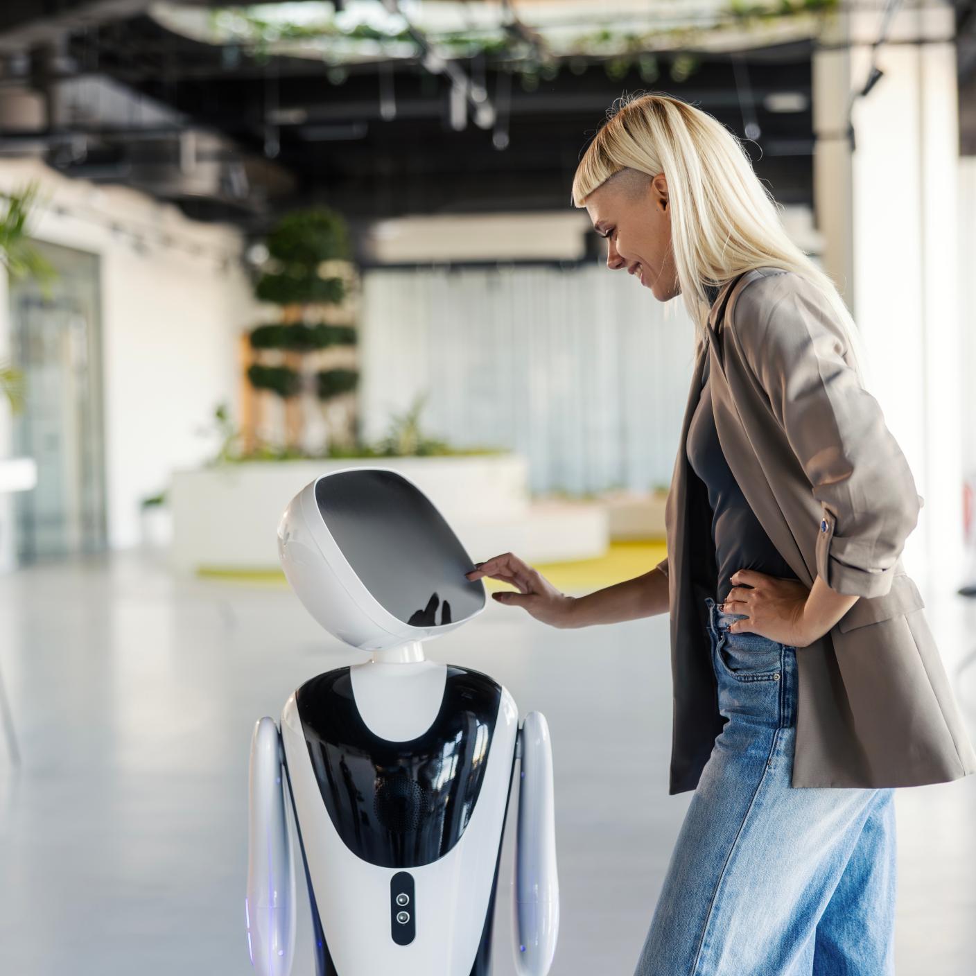 Person interacting with service robot in a modern office