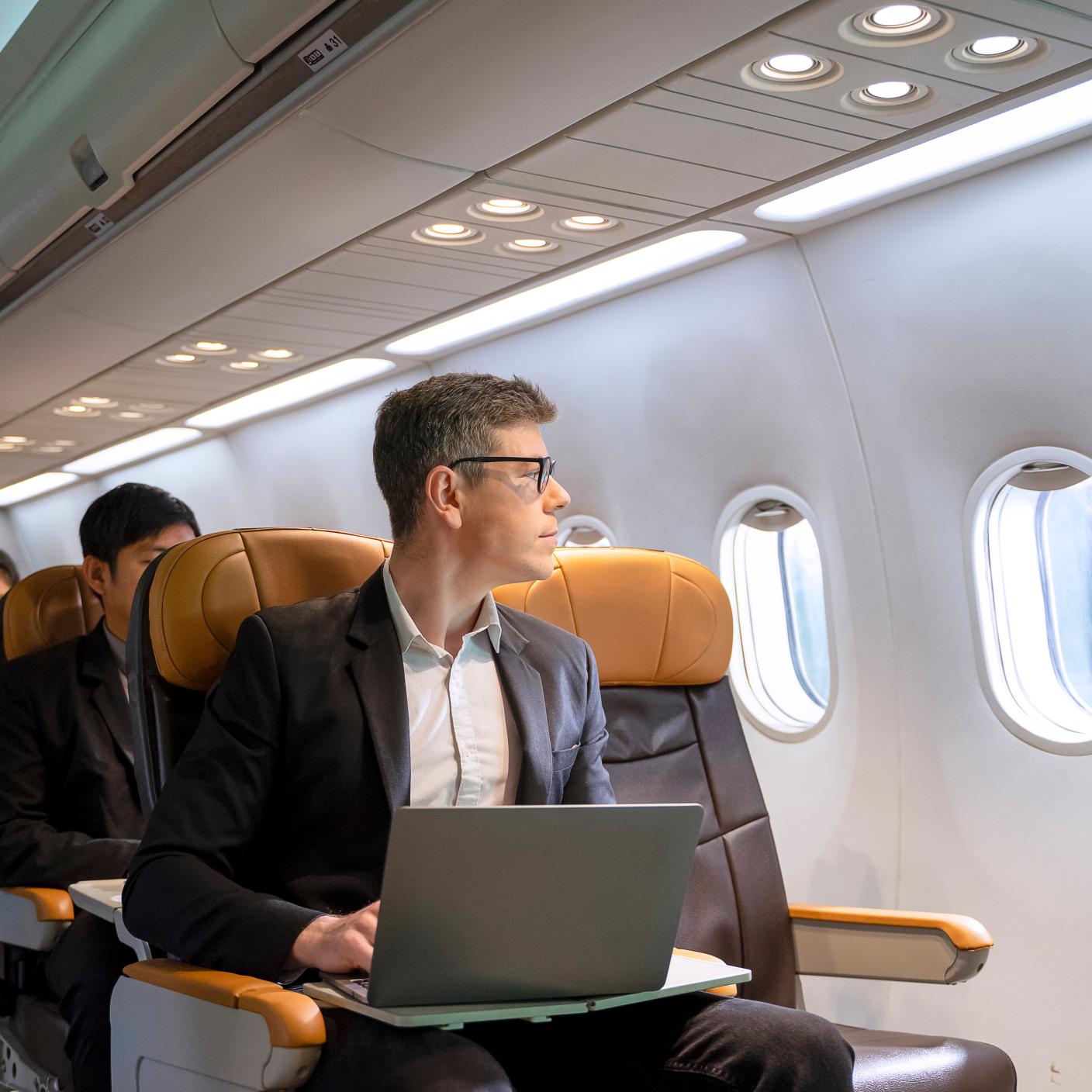 Passengers are sitting in the commercial plane.