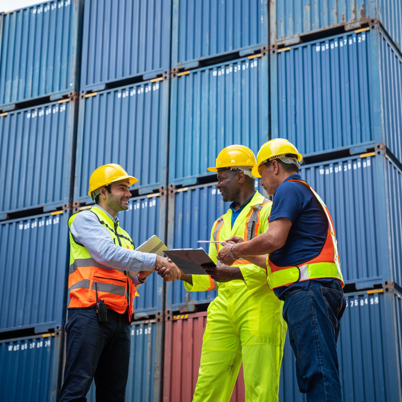 Male Industrial Engineer and Foreman control checking container at container yard warehouse. Logistics business. Import and export concept.