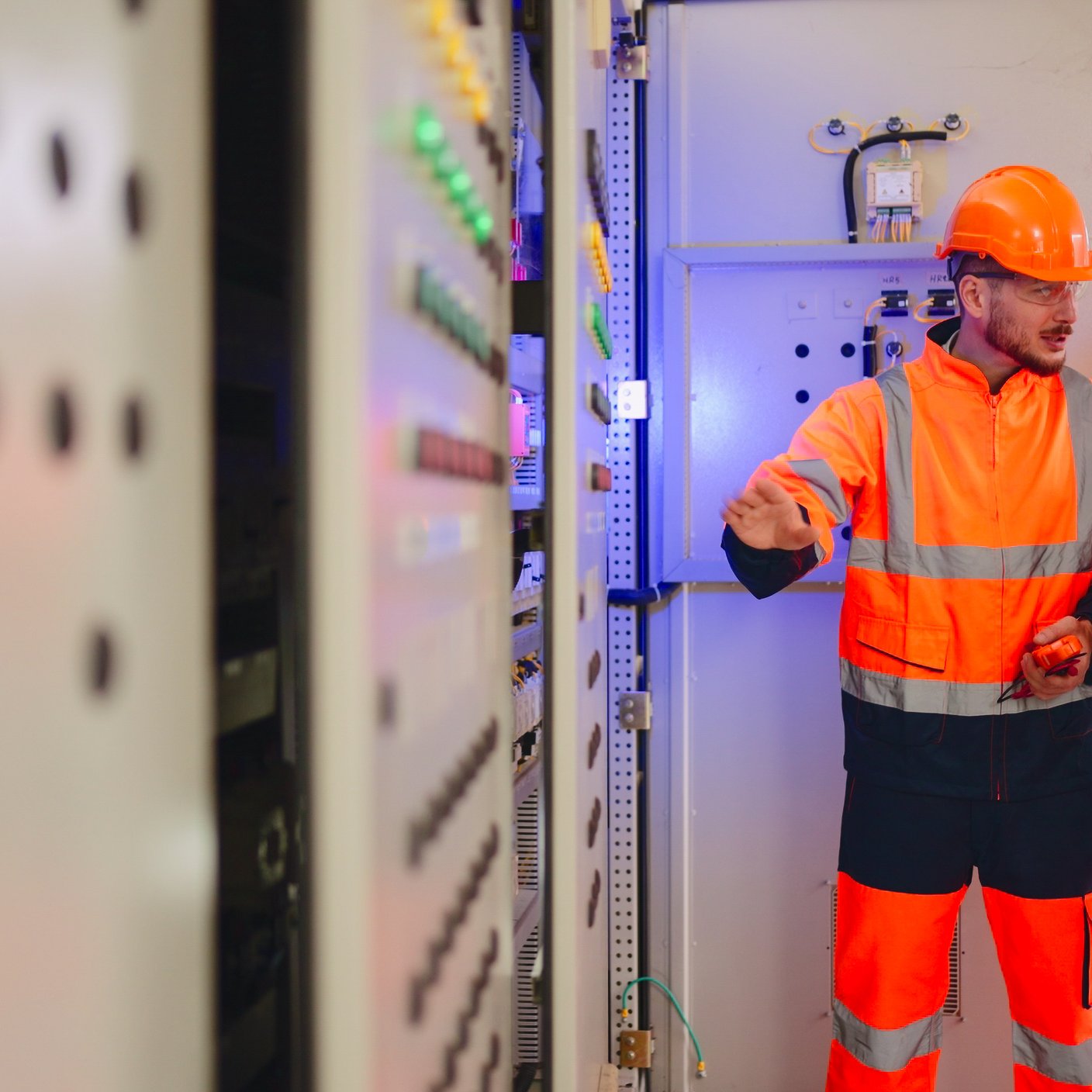 Two Electrical engineer working in control room at industry factory.