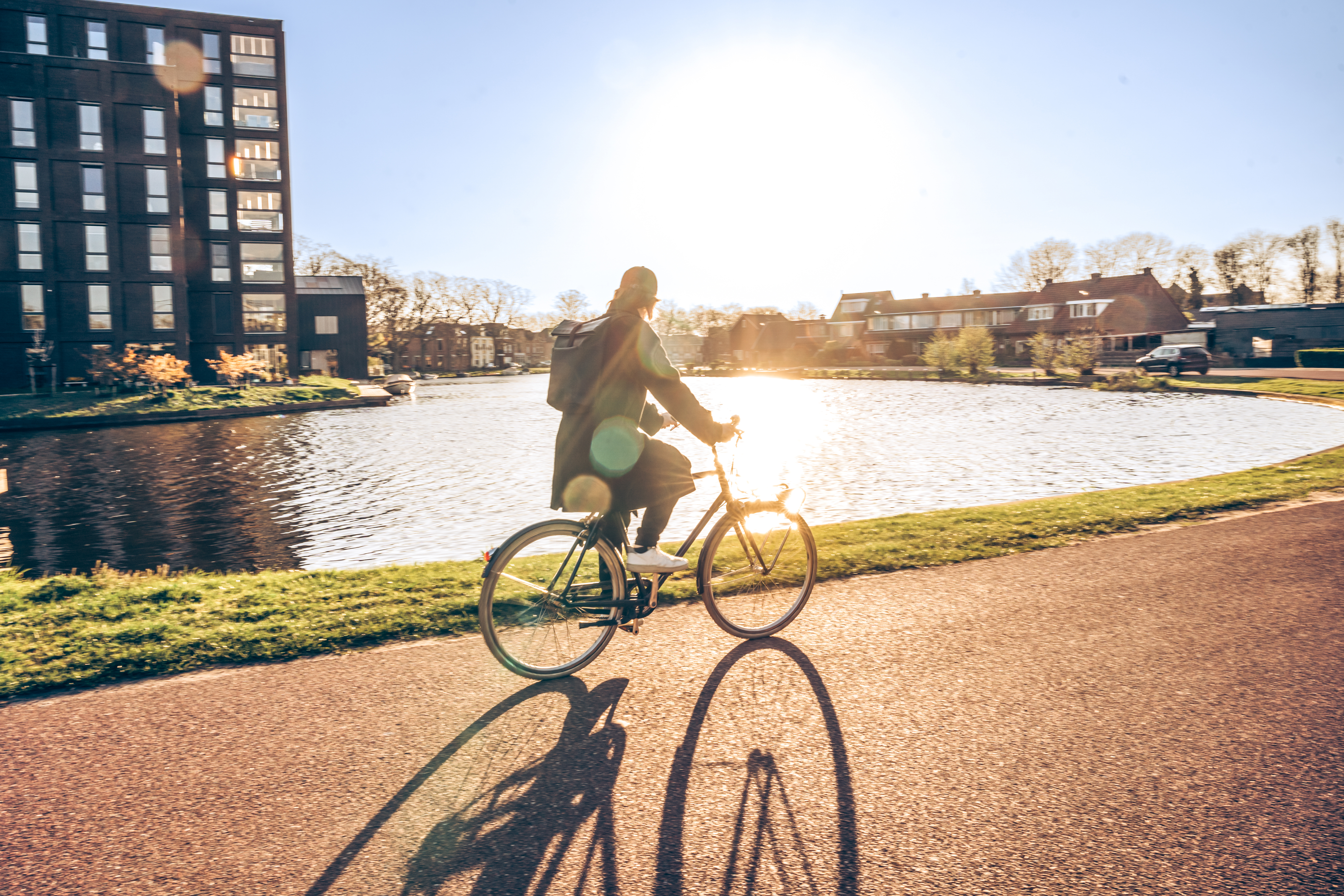 Quiet residential commute by bicycle along a scenic waterfront route. A modern answer to congestion and pollution