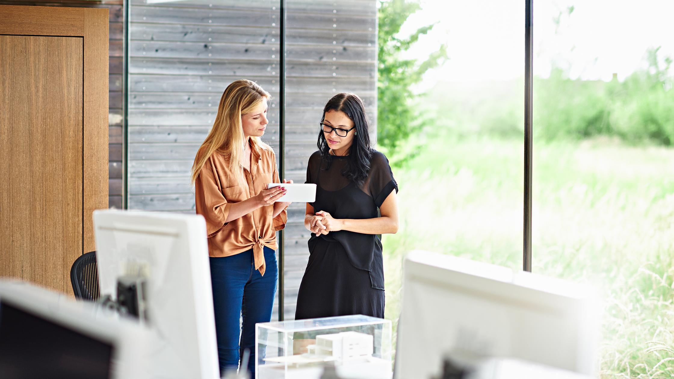 Two architects discussing plans in a digital table