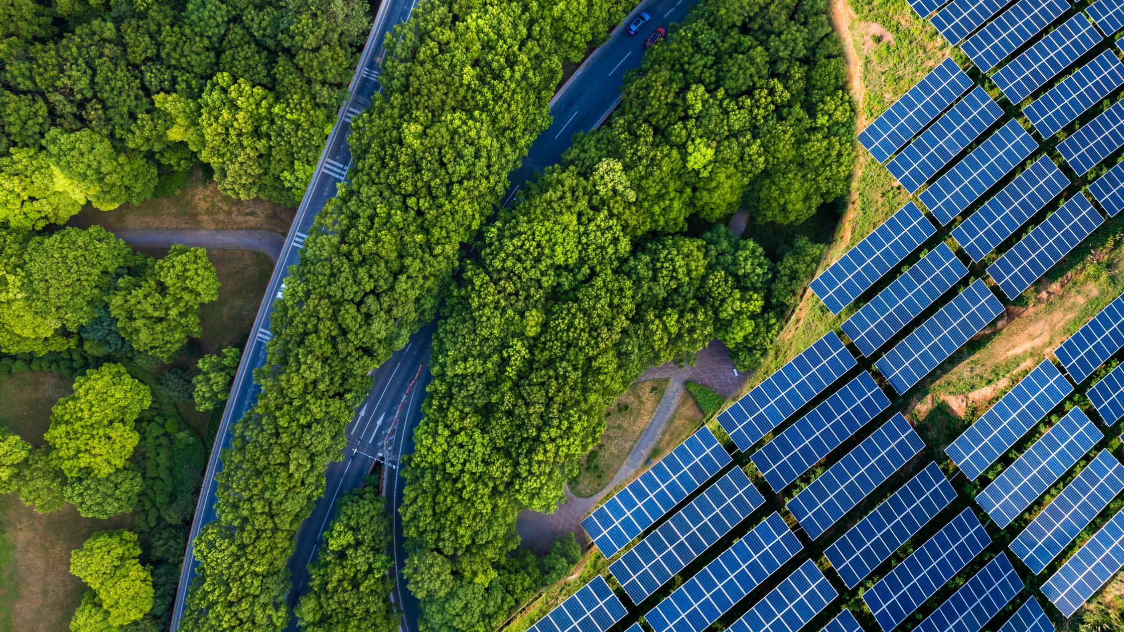 High angle view of Solar panels , agricultural landscape. Winding coastal road on turquoise coloured lake. Pudong, shanghai, China