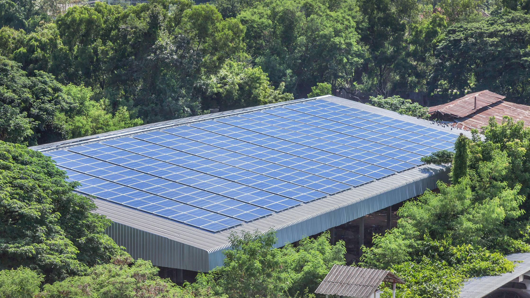 Rows array of polycrystalline silicon solar cells or photovoltaics installing on roof factory
