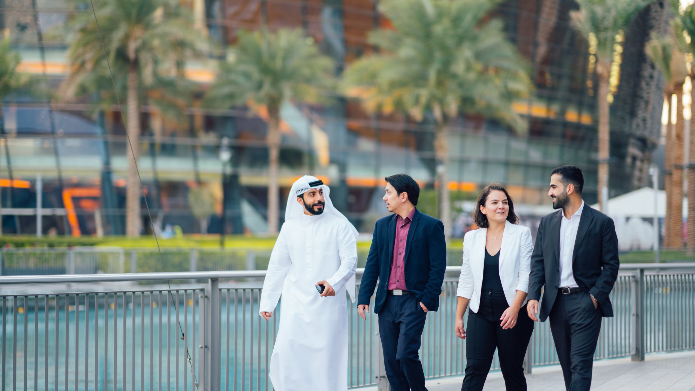 A group of people walking while discussing business