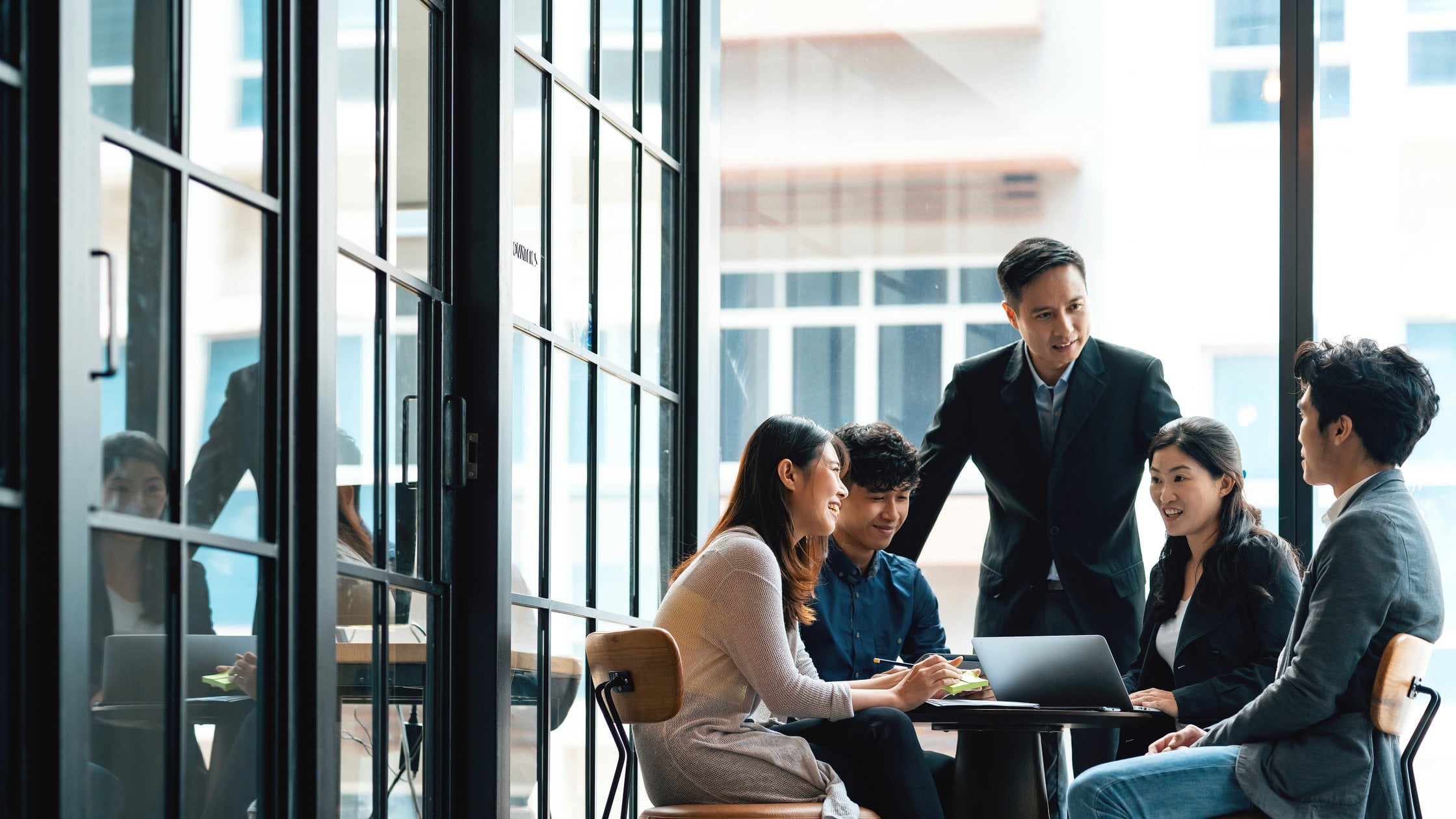 Young creatives and team leader in discussion in an open working environment